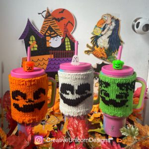 Three knitted tumbler sweaters featuring 90s inspired designs from McDonalds Halloween boo buckets